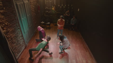 group of theater actors having class with stage director