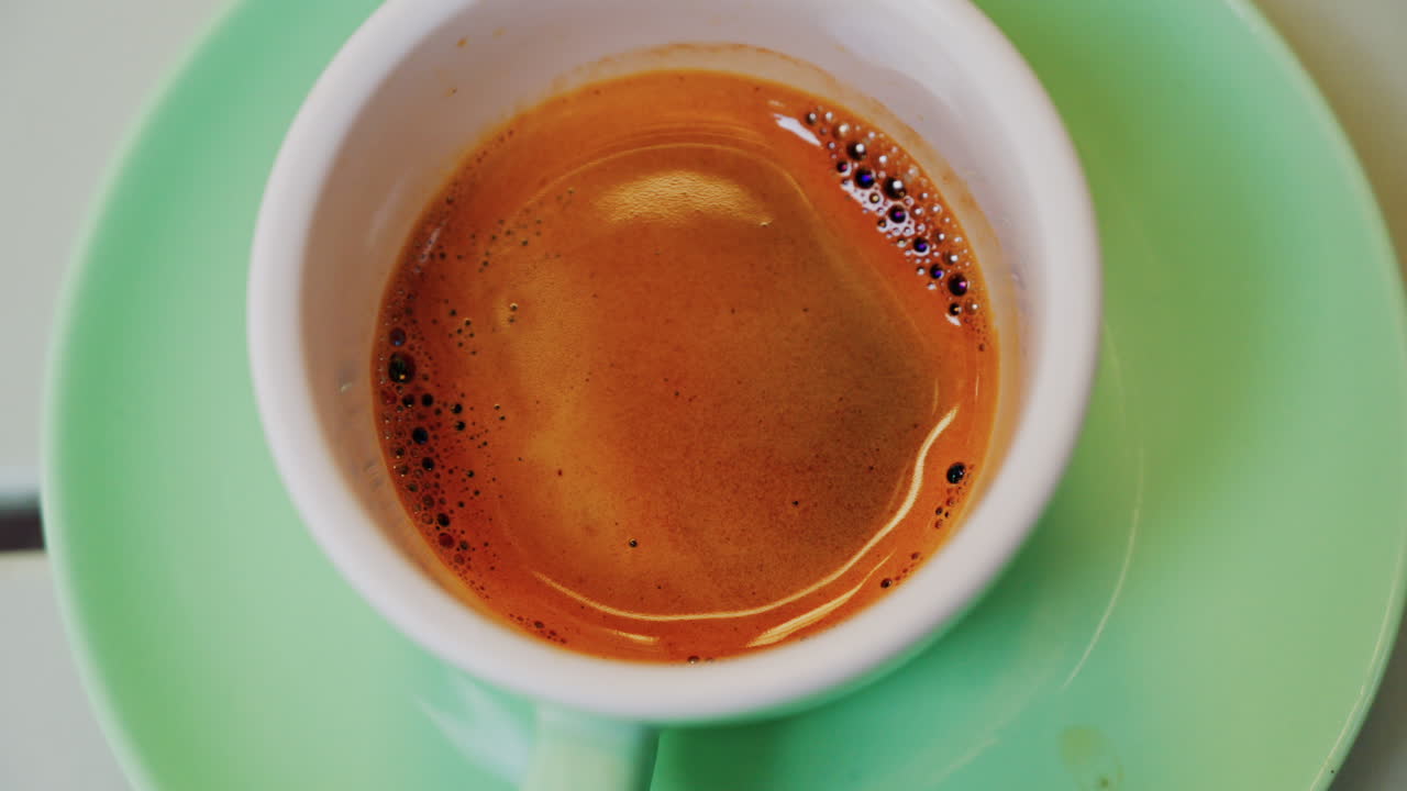 Close up of an espresso cup on a green plate