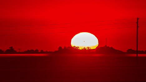 misty fog over countryside fields flowing over the landscape at sunrise - zoomed in time lapse