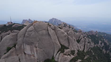montserrat mountain range under hazy sky due to air pollution, spain
