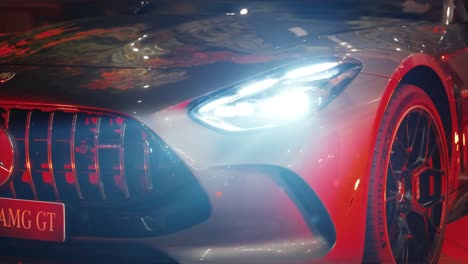 close-up of a grey mercedes-amg gt at night