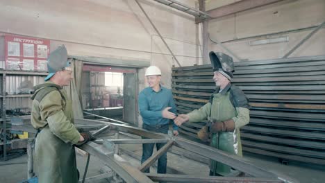 factory workers handshake