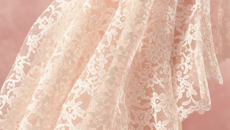 delicate lace fabric displaying intricate floral patterns against a soft pink background, perfect for wedding or fashion projects