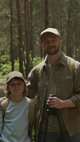 father and son hiking in the forest