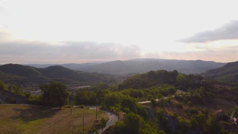 Aerial-wide-shot-of-a-beautiful-Italian-mountain-valley-on-a-sunny-day