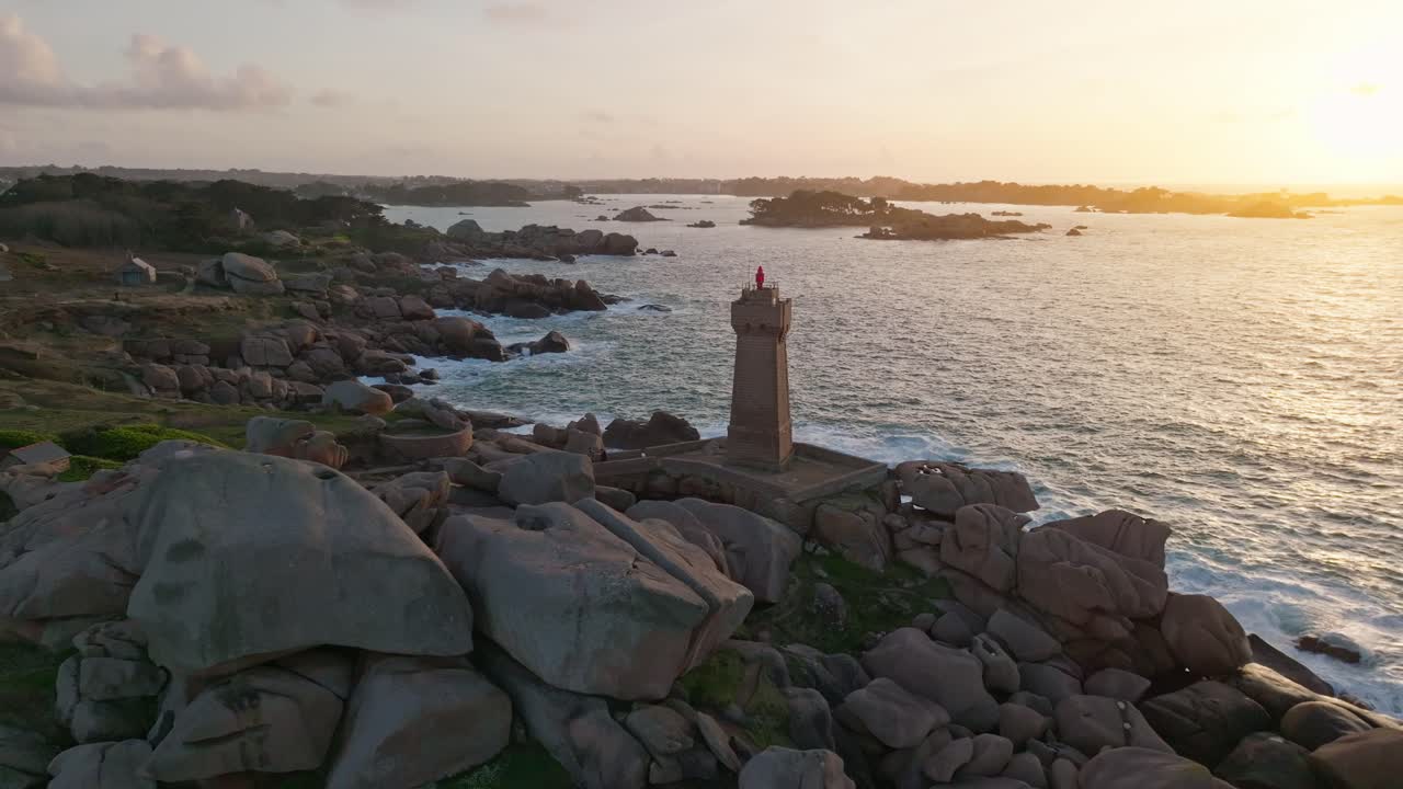 Slow Fly-Back shot of Phare Du Mean Ruz Lighthouse in Bretagne France During sunset