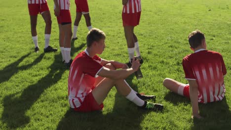 rugby players resting on the field