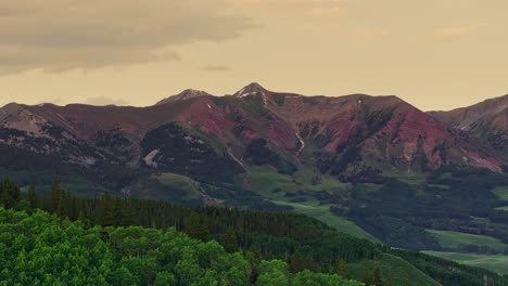 Aerial-over-green-hills-near-the-Crested-Butte-mountain,-Colorado,-USA