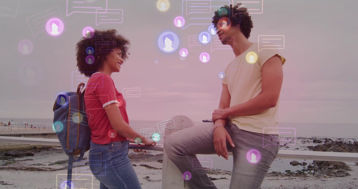 Two friends tapping smartphones starting tech chat while animated message bubbles floating on beach