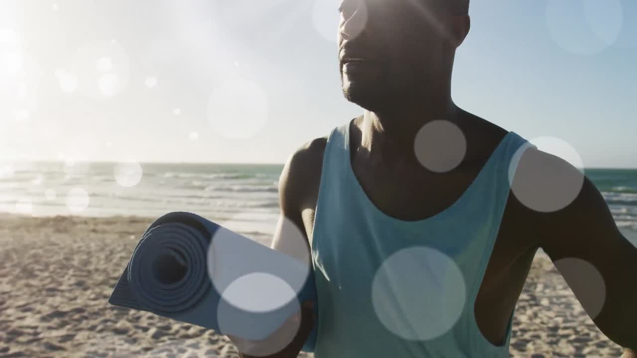Animation of glowing lights over an exercising african american man