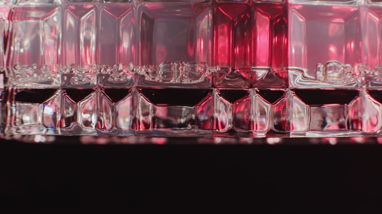 Close-up of a faceted glass filled with red liquid