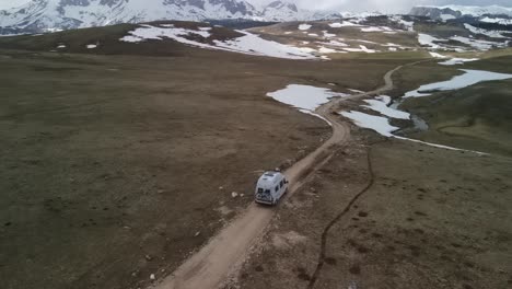 aerial following camper van driving along a mountain top, montenegro