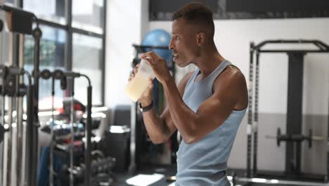 man drinking protein shake in the gym