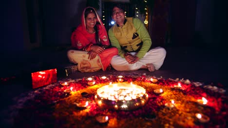 couple celebrate a colorful diwali rangoli- red pink orange green