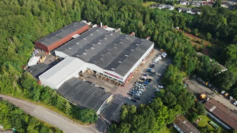 beautiful aerial view of a small industrial plant in a rural area with green trees on a sunny summer day