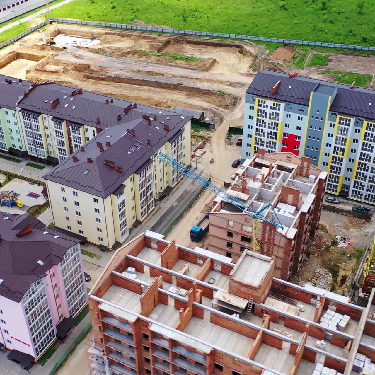 Construction site of a modern district in the city. Colorful urban buildings in a new microdistrict. Building with a bird's eyes