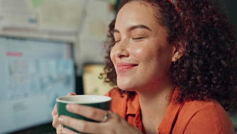 woman drinking coffee at her desk
