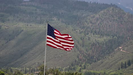 large american flag gently waving in the wind with the san juan mountains in background