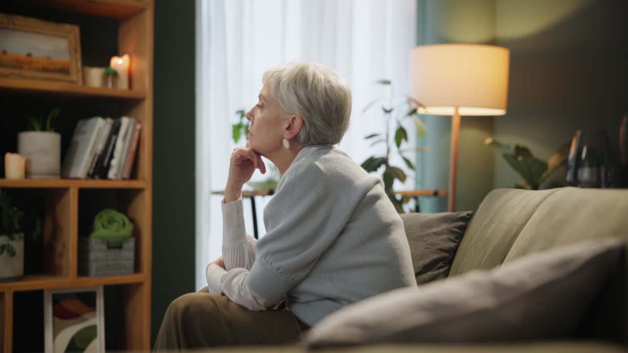 Senior woman thinking in her living room