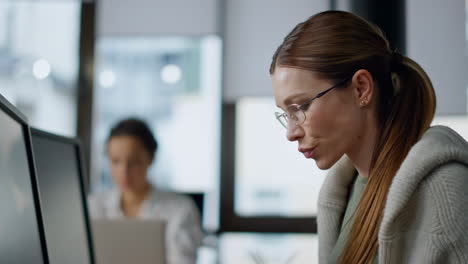 pensive developer analyzing software closeup. thoughtful woman looking computer