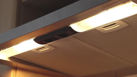 starting and closing the stove hood with the light in the kitchen