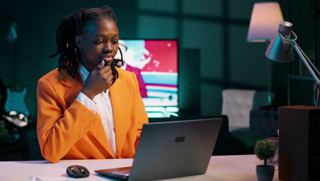 focused student engaging in her studies at home office with laptop
