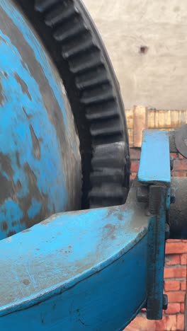 close up shot of gears driving a portable cement mixer, industrial construction machinery.