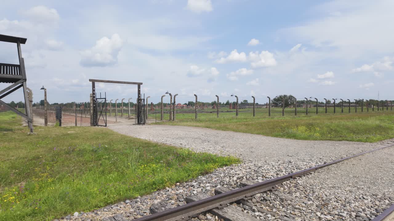 Birkenau’s vast fields and solemn paths with watchtowers, reflecting the horrors of Holocaust