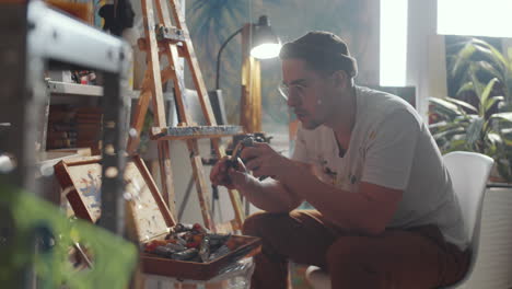 artist preparing paints for working in studio