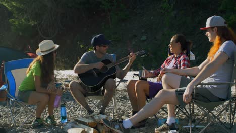 group of friends camping near riverside 4k