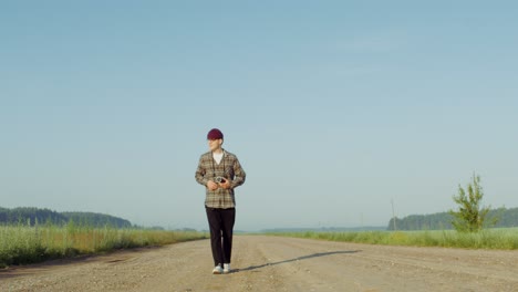 photographer walking on a country road