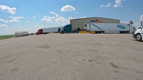 pov - driving though the truck parking lot towards the tire repair shop for love's travel stop; concepts of logistics, road trip and highway transportation
