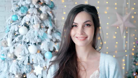woman smiling at christmas tree