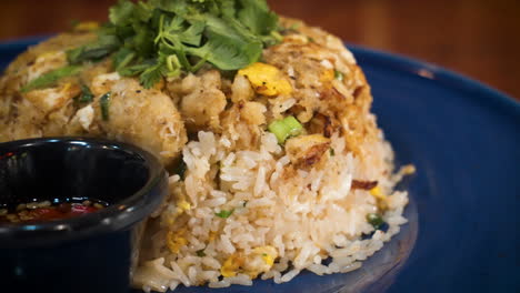 close up of restaurant dish crab fried rice topped with cilantro, slider 4k