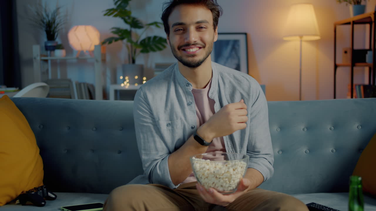 Man Watching Movie at Home with Popcorn
