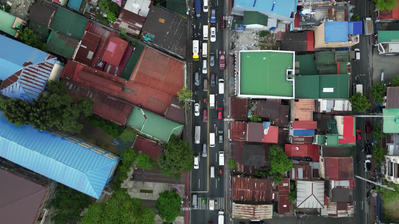Aerial top-down view of heavy traffic on roads in Marikina City, Philippines residential area.