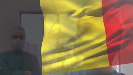 animación de ondear la bandera de bélgica contra un cirujano y una cirujana caucásicos en el hospital