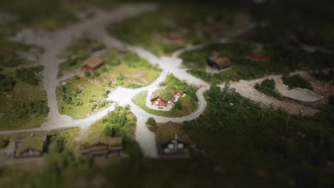 made using tilt shift style an aerial view on a grass roof cabin situated in a tiny norwegian village located on green scandinavian hills