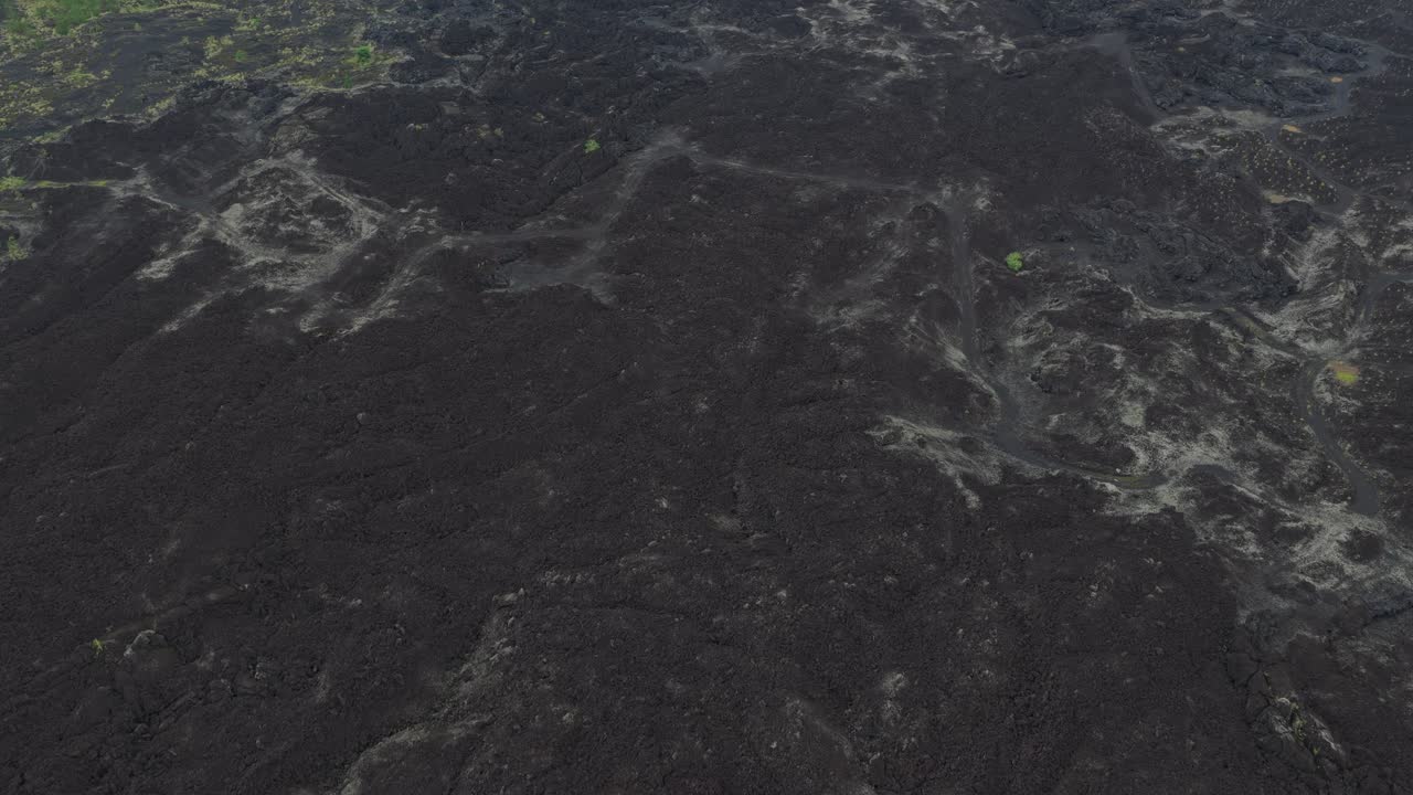 Volcanic landscape of mount batur flying over solidified lava fields