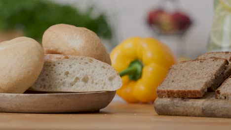 slide right shot 4k of two types of bread, white bread made of wheat flour and wholemeal rye bread