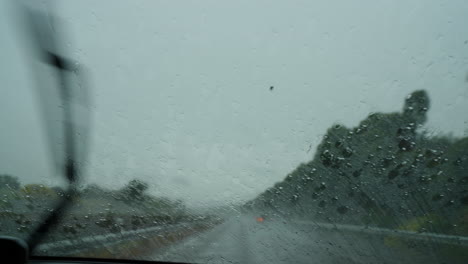 highway view through rainy windshield