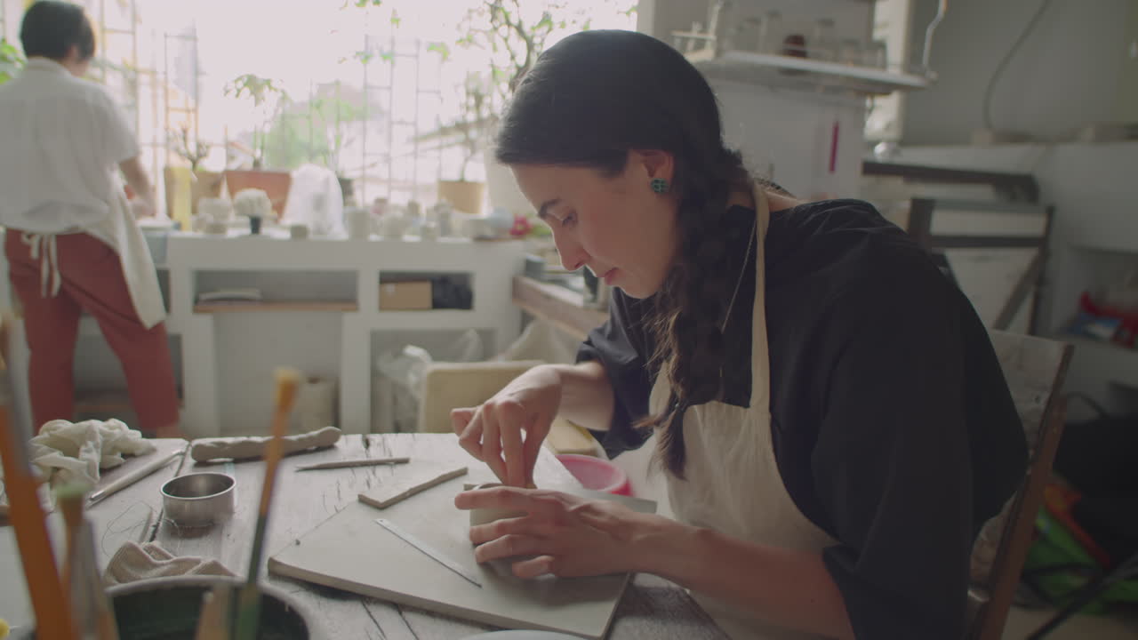 Young Woman Working with Clay at Pottery Class