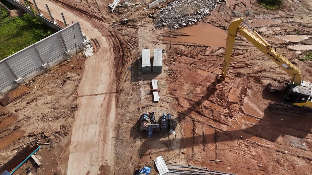 Construction Site with Excavator and Building Materials