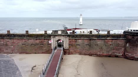 fort perch rock new brighton sandstone coastal defence battery museum lighthouse aerial close left orbit view