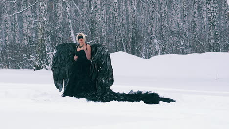 lady in phoenix costume touches invisible wall in forest