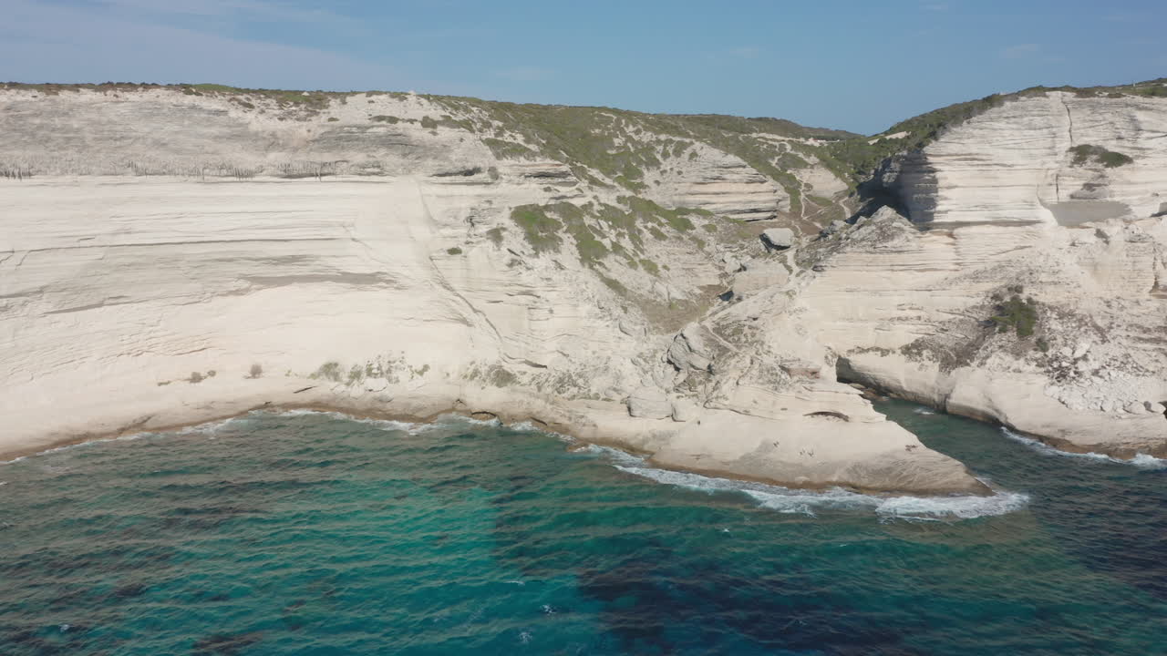 Bonifacio Corsica aerial drone shot coastline cliffs rugged limestone the turquoise Mediterranean Sea iconic French island landscape