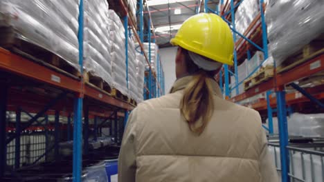 young female worker walking in a warehouse