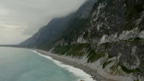 Qingshui-cliffs-rising-aerial-view-across-Taroko-gorge-Hualien-cloudy-mountain-shoreline