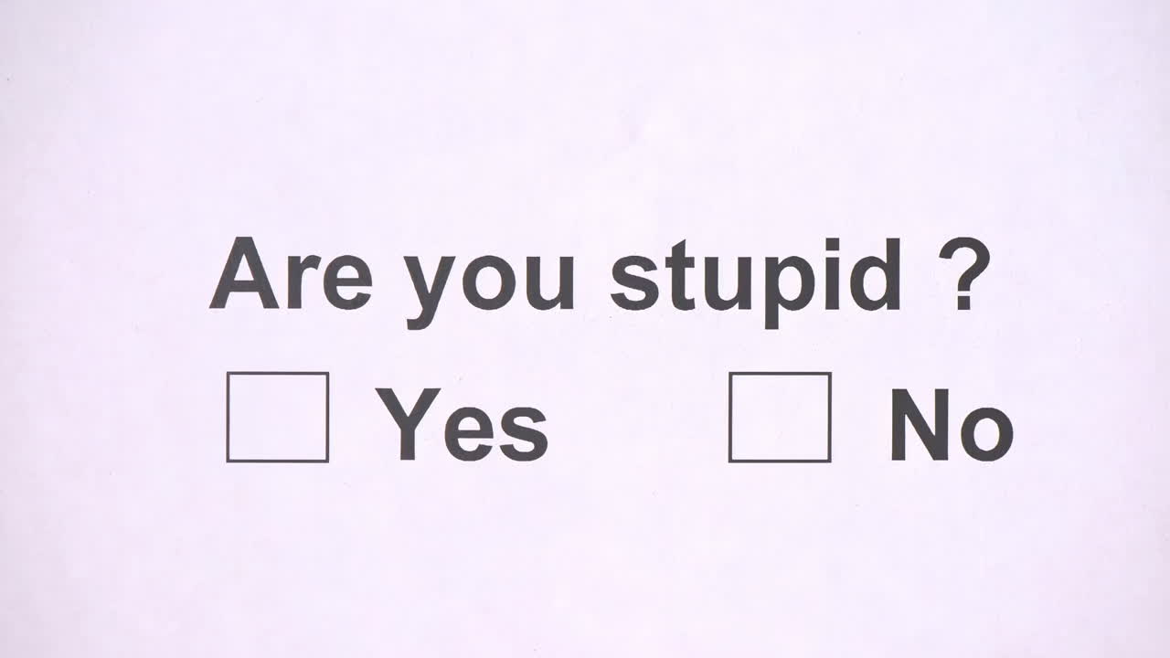 Overhead shot of a caucasian man answering to the question: Are you stupid? on the white piece of sheets