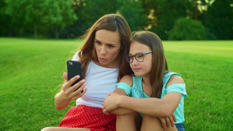 mother and daughter talking online by video call